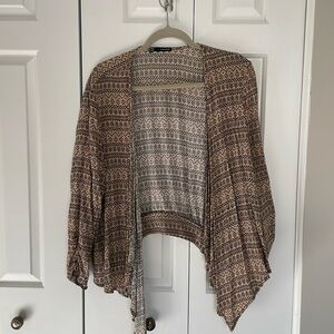 Brown and black shrug cardigan. Zipper detail in the back.